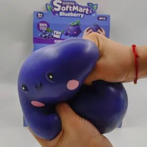 Detailed view of a giant blueberry squishy toy being squeezed for slow rebound stress relief
