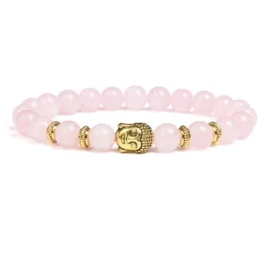 Detail view of pink crystal bead bracelet with gold Buddha head pendant and spacer components.