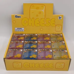 Detail of creative cheese cube squishy toys in colorful 12-piece display box packaging.
