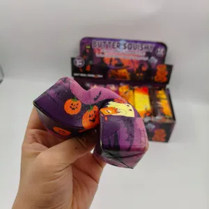 Detailed close-up view of hand squeezing Halloween pumpkin slow rising squishy toy