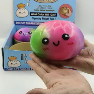 Detailed view of large colorful squishy bun toy held in hands for scale