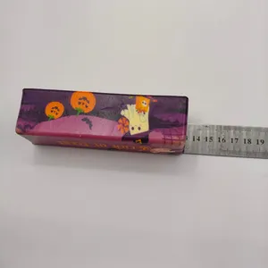 Detailed view of Halloween ghost squishy toy measured against a metal ruler for scale