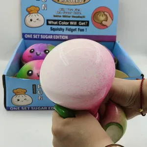Close-up of 15cm pink giant squishy bun being squeezed for slow rebound stress relief.