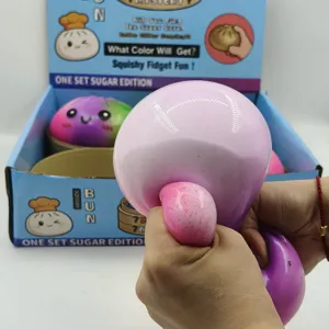 Close-up of hands squeezing a large colorful steamed bun-shaped squishy stress relief fidget toy