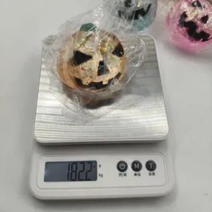 Weight detail of Halloween pumpkin squishy toy on a digital scale showing 182.2g