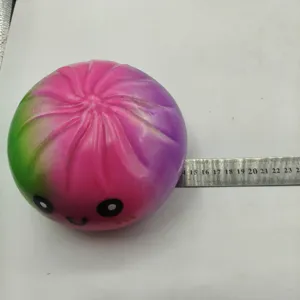 Macro detail of a 15cm colorful gradient squishy steamed bun toy shown with ruler