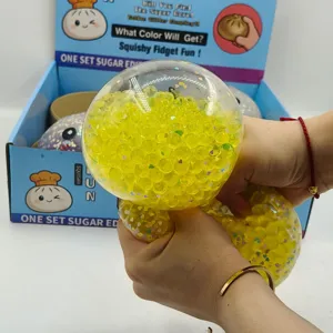 Κοντινό πλάνο 15cm κρυστάλλινου squishy baozi γεμάτου με κίτρινες χάντρες που πιέζεται