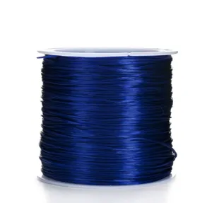 Detailed close-up view of dark blue flat elastic cord on white spool for DIY beading.