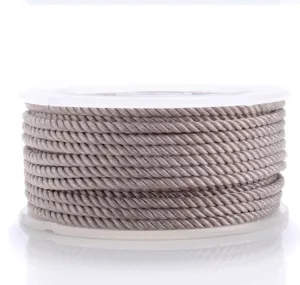 Close up of grey braided nylon cord spool, ideal for DIY jewelry making and crafts details.