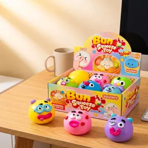 Close-up of colorful Bun Squeeze stress relief toys in a retail display box on a desk