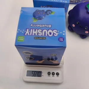 Detailed weight measurement of the large blueberry squishy toy on a digital scale.