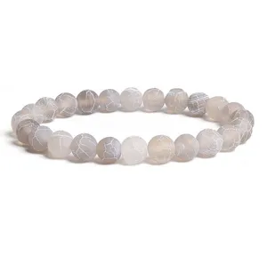 Detailed close-up of frosted weathered agate beads bracelet, natural cracked texture design.