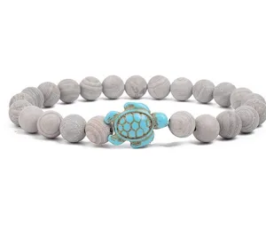 Beaded bracelet featuring gray textured stone beads and a charming blue turquoise turtle pendant.