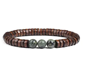 Detailed view of wooden spacer bracelet featuring three green stone beads in the center.