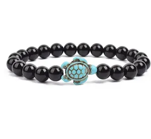 Black beaded bracelet featuring a charming turquoise turtle pendant detail for daily wear.