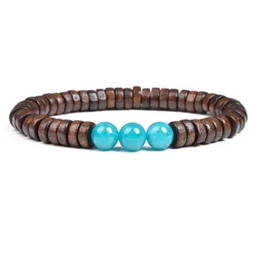 Close-up detail of wooden disc spacer beads paired with three vibrant blue turquoise beads.
