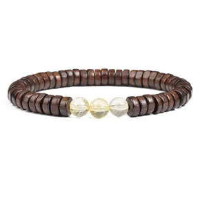 Detailed close-up view showcasing wooden disc beads and central yellow crystal bracelet.