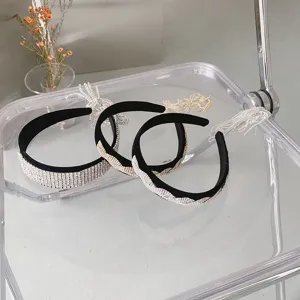 Detailansicht von drei Vintage-Strass-Stirnbändern mit Fransen auf einem klaren Stuhl