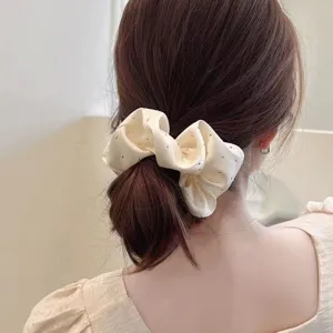 Back view of cream fabric scrunchie with sparkling rhinestones in a ponytail hairstyle
