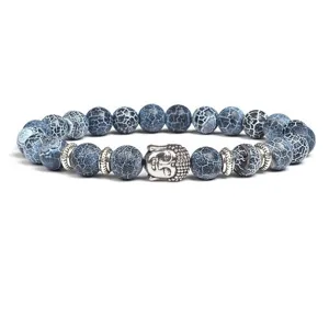 Blue crackled agate beaded bracelet with metal Buddha head charm and spacer beads detail view.