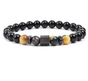 Close-up detail of 8mm tiger eye gemstone and black obsidian beaded bracelet with micro-paved spacer.