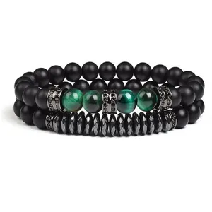 Close-up detail of double layer beaded bracelet with green tiger eye and black stone.