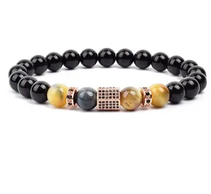 Detailed view of 8mm black tiger eye bead bracelet with micro-paved rose gold spacers.