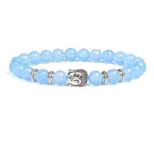 Detailed closeup of 8mm blue beaded bracelet featuring silver Buddha head charm and metal spacers.