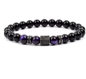 Detailed close-up of beaded bracelet with black and purple stones and micro-pave metal spacers.