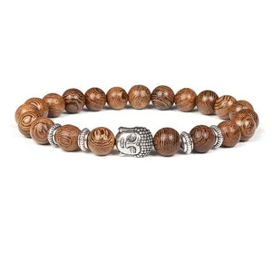 Wooden beaded bracelet with Buddha head and metal spacers, stylish unisex jewelry accessory.
