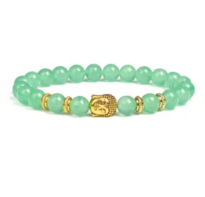 Green gemstone bead bracelet with gold Buddha head and metal spacers detail shot.