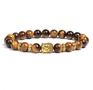 Detail shot of natural tiger eye stone beaded bracelet with golden Buddha head charm and spacers.