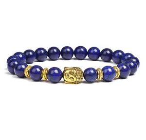 Closeup detail of blue lapis lazuli beaded bracelet with gold Buddha head charm and spacers.
