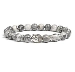 Detail shot of grey stone beaded bracelet with silver Buddha head charm and metal spacer accents.