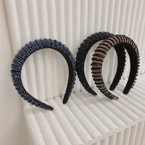 Close-up of three baroque wide headbands with intricate crystal beadwork details.