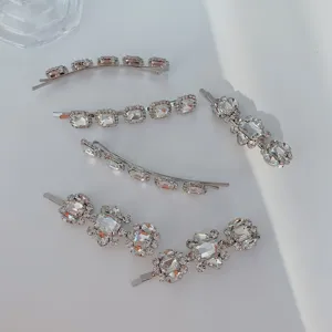 Detailed macro view of silver alloy hairpins set with clear sparkling rhinestones