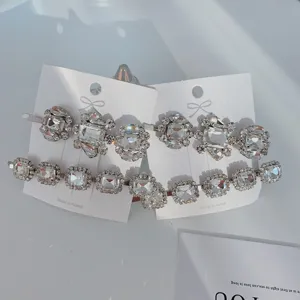 Close-up detail of sparkling crystal rhinestone hair clips on white display cards