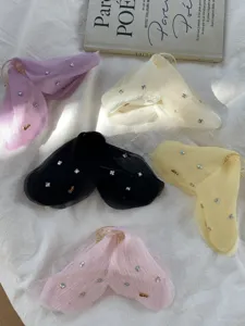 Detailed view of ethereal tulle butterfly hair claw clips with sparkling rhinestone accents