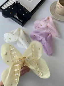 Detailed macro view of large tulle butterfly hair claws in multiple pastel colors