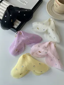 Detail view of sheer mesh hair claw clips in pastel colors with crystal accents