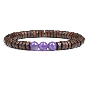 Close-up view of dark wooden disc beads bracelet featuring purple crystal stones detail.