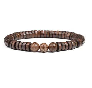 Close-up detail of natural wood beaded bracelet showing unique grain pattern and texture.