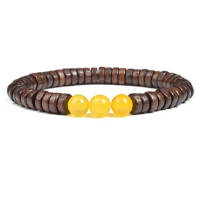 Detail view of the wooden disc spacer and bright yellow gemstone bead DIY bracelet.