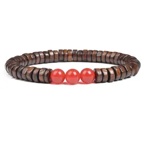 Close-up detail of the wooden disc beads and red agate round stones bracelet craftsmanship.