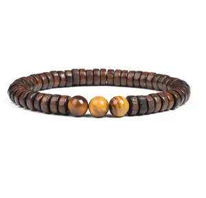 Close-up detail of natural wood spacer beads bracelet featuring three center tiger eye round stones.