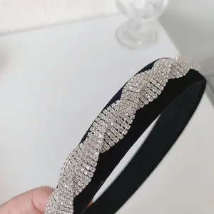 Detailansicht der luxuriös glitzernden Strass-Wellenform auf schwarzem Samt-Haarreif.