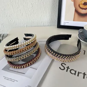 Close-up view of stylish PU leather headbands with interwoven gold alloy chain details