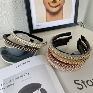 Close-up of multi-colored alloy chain and PU leather braided thin headbands for women