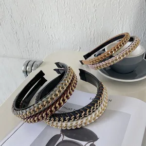 Detail shot of elegant PU leather headbands with interwoven gold alloy chains