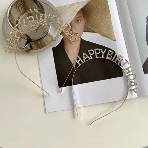 Close-up of gold and silver rhinestone "HAPPY BIRTHDAY" headbands for party wear.